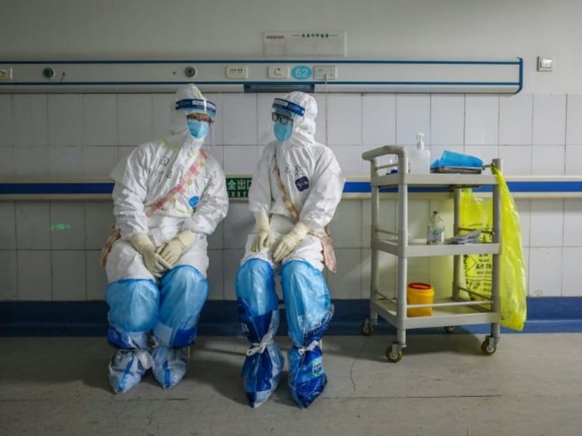 Doctors and nurses treating virus patients in China's overstretched hospitals struggle to deal with the health crisis amid a shortage of basic medical items.