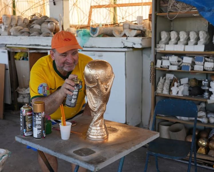 In Rio, artisan crafts World Cup trophies while hoping Brazil gets a real one