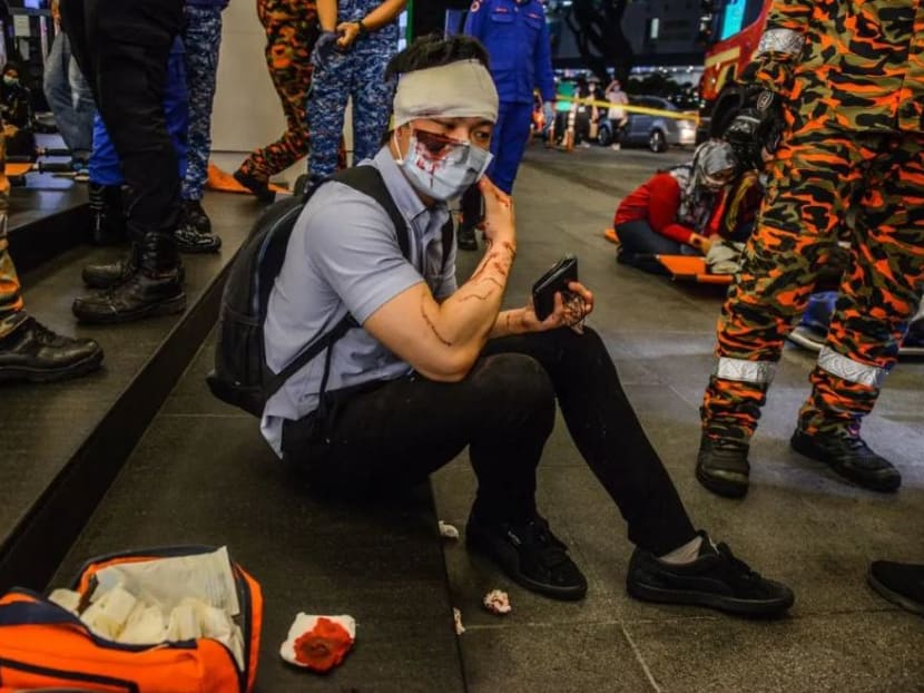 An injured commuter is seen in the aftermath of a train collision in Kuala Lumpur on Monday, May 24, 2021.