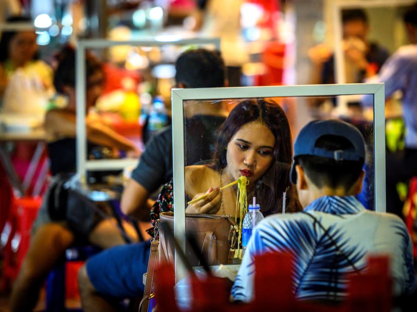 People eat at a street restaurant in Bangkok's Chinatown on May 21, 2020.