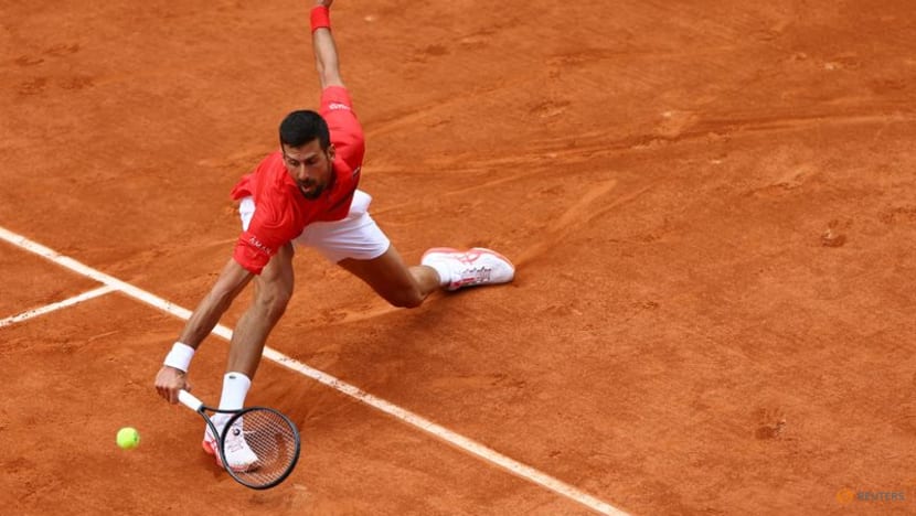 Djokovic saves set point, battles past Moutet to stay on course for record Grand Slam