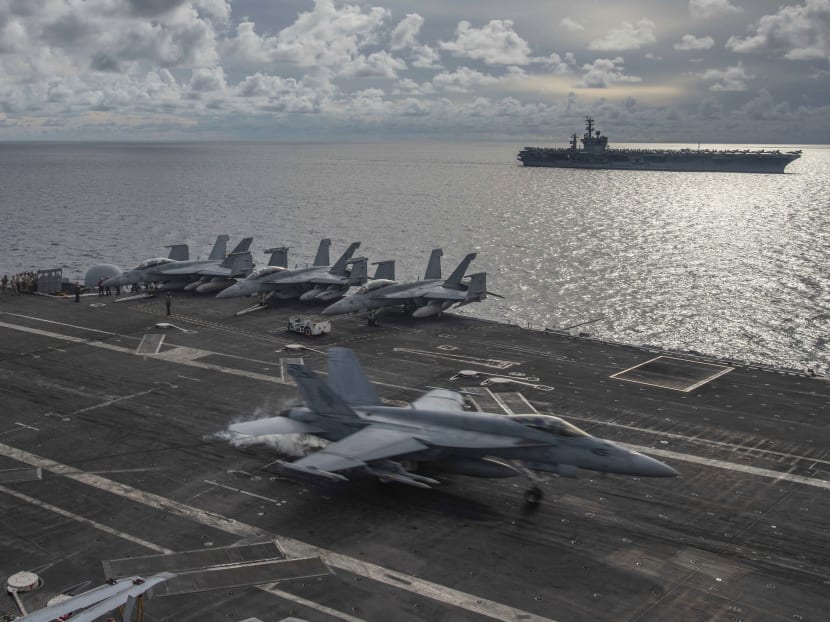 In this photo provided by the US Navy, an F/A-18E Super Hornet lands on the flight deck of the USS Ronald Reagan in the South China Sea, July 6, 2020. In this photo provided by the US Navy, an F/A-18E Super Hornet lands on the flight deck of the USS Ronald Reagan in the South China Sea, July 6, 2020.