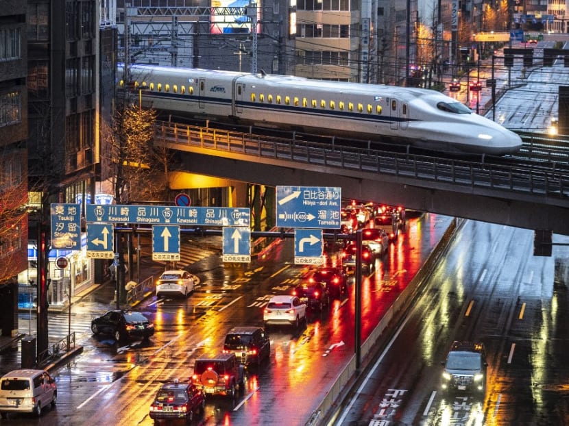 A shinkansen N700A series, or high speed bullet train, arrives at night in Tokyo on March 21, 2021.
