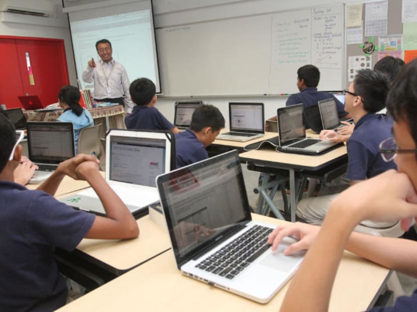 Students at the School of Science and Technology key in their responses on their laptop during a lesson. One of the infrastructure tenders for FY2016 will be for a massive expansion of Wi-Fi systems in schools to support smart learning. TODAY file photo