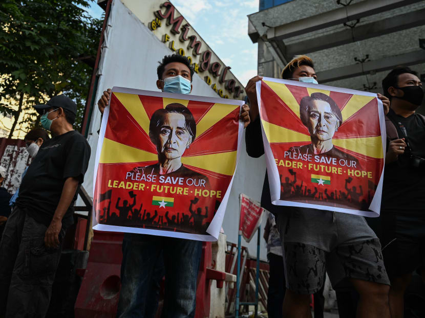 Protesters hold signs with the image of detained civilian leader Aung San Suu Kyi during a demonstration against the military coup in Yangon on February 8, 2021.