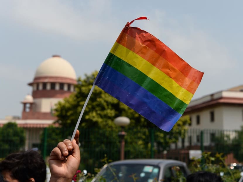 An Indian member of the lesbian, gay, bisexual, transgender (LGBT) community waves a flag outside the Supreme Court building as crowds gathered to celebrate the decision to strike down the colonial-era ban on gay sex in New Delhi on Sept 6, 2018. An Indian member of the lesbian, gay, bisexual, transgender (LGBT) community waves a flag outside the Supreme Court building as crowds gathered to celebrate the decision to strike down the colonial-era ban on gay sex in New Delhi on Sept 6, 2018.