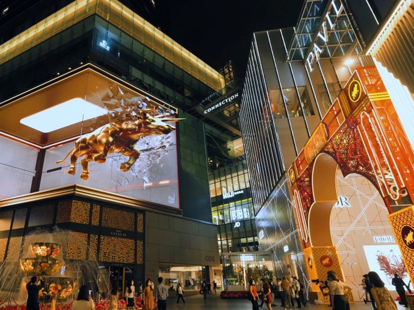 The bull is seen getting spray painted a glimmering gold before it charges and “jumps” through the screen, a symbolic gesture of chasing away the Covid-19 blues and bringing wealth and health to the nation. The bull is seen getting spray painted a glimmering gold before it charges and “jumps” through the screen, a symbolic gesture of chasing away the Covid-19 blues and bringing wealth and health to the nation.