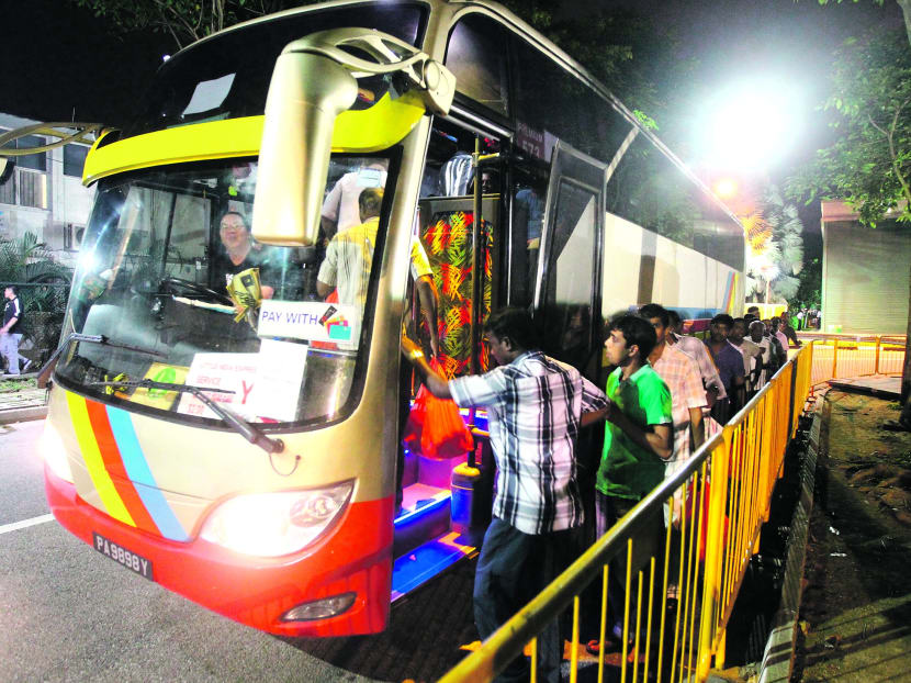 Workers boarding the buses in an orderly manner at Little India. Photo: Ernest Chua