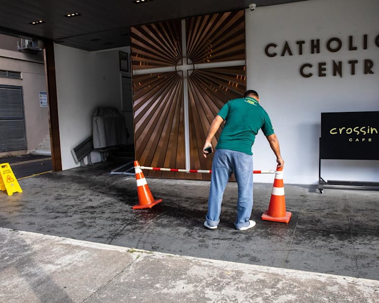 CCTV shows '7 to 8' people getting out of 2 cars and spraying unknown substances outside Catholic Centre, say workers