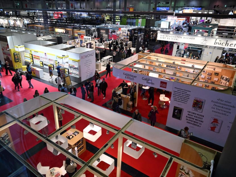 A general view taken on Oct 19, 2023 shows visitors walking past booths of German publishing houses Rowohlt and Kiepenheuer & Witsch at The Frankfurt Book Fair in Frankfurt am Main, Western Germany. A general view taken on Oct 19, 2023 shows visitors walking past booths of German publishing houses Rowohlt and Kiepenheuer & Witsch at The Frankfurt Book Fair in Frankfurt am Main, Western Germany.