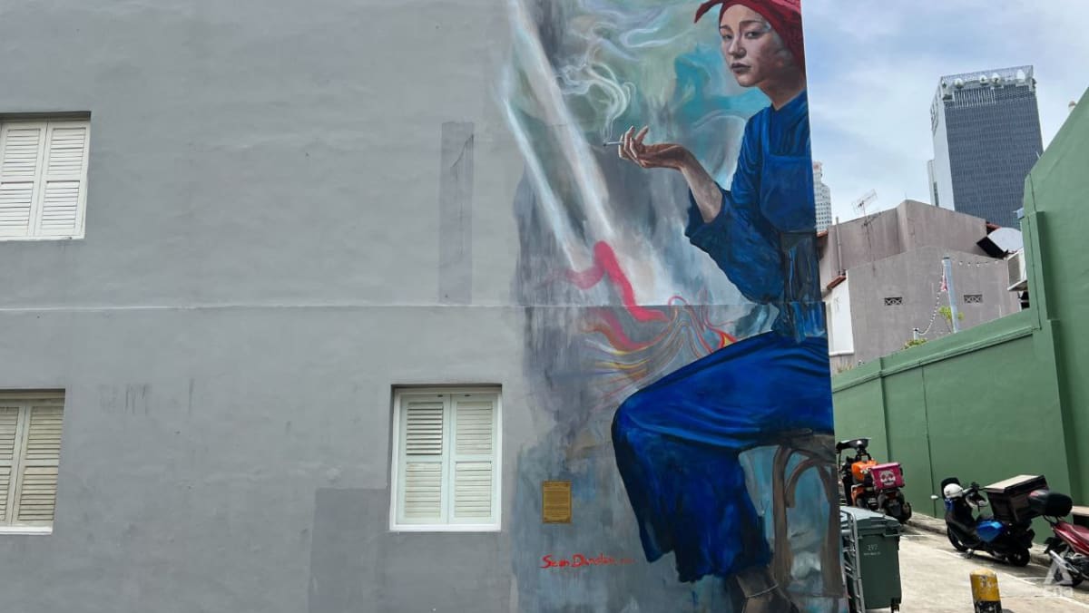 Plaque containing anti-smoking message installed at smoking samsui woman mural