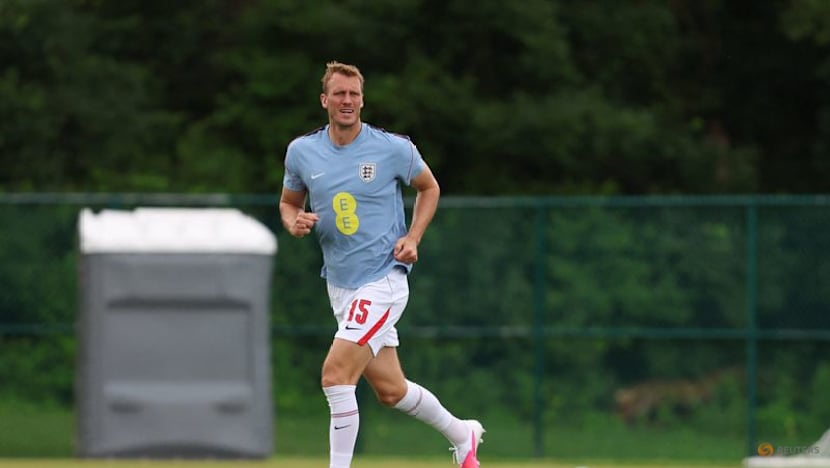 England's Burn swaps football boots for cowboy boots during break between games