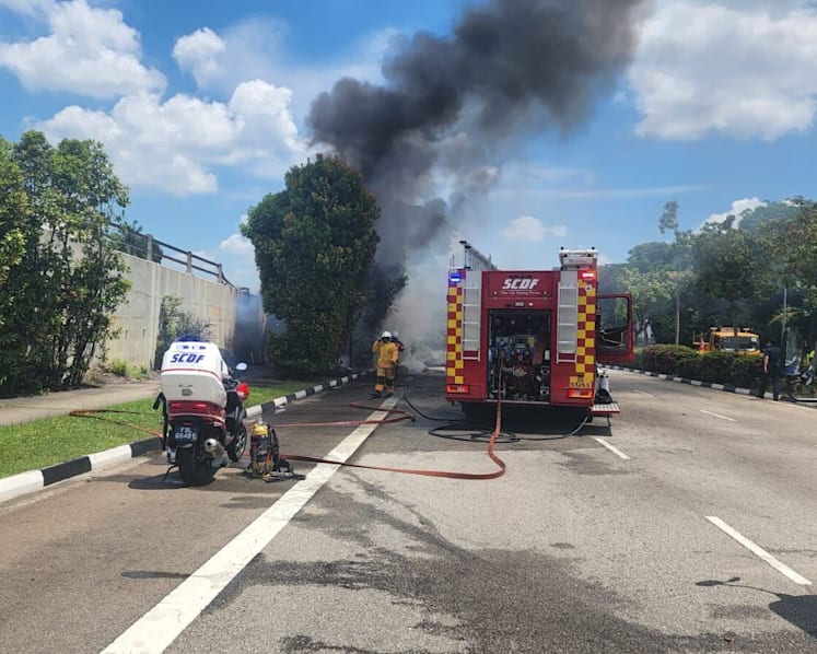Driver taken to hospital after truck overturns, catches fire; witness hears explosion, helps douse flames