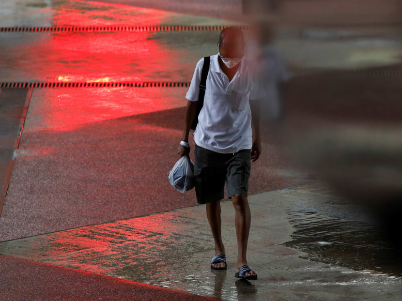 A man wearing a protective face mask crosses a street amid the Covid-19 outbreak in Singapore, June 1, 2020. A man wearing a protective face mask crosses a street amid the Covid-19 outbreak in Singapore, June 1, 2020.