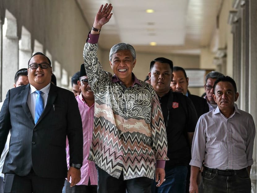 Umno president Ahmad Zahid Hamidi handed over his duties to his deputy, Mohamad Hasan, after facing growing pressure within the party to quit.