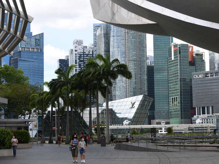 People walk through the promenade at Marina Bay Sands hotel and resorts in Singapore on Dec 14, 2020.
