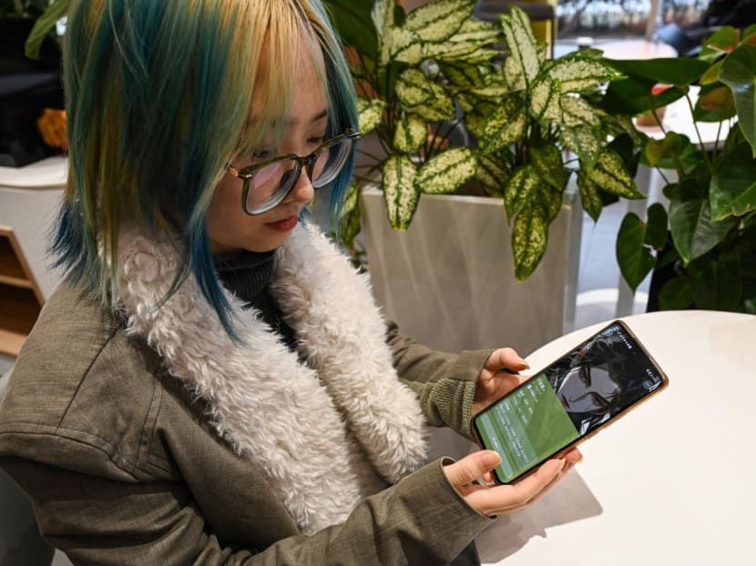 Ms Wang Xiuting showing her virtual boyfriend on Wantalk — an artificial intelligence chatbot created by Chinese tech company Baidu, on her phone at a cafe in Beijing.