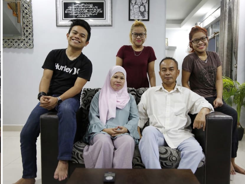 From left) Madam Vanaja Ramanathan (seated) with her sons Vasanthan and Logindran Balachandran in their rented flat in Singapore. The Anuar family who live in Johor: Erwin Isqandar Anuar, Madam Zainon Saini, Eleana Adriana, Mr Samsul Anuar, Edlyn Adriana. Photos: Raj Nadarajan/TODAY
