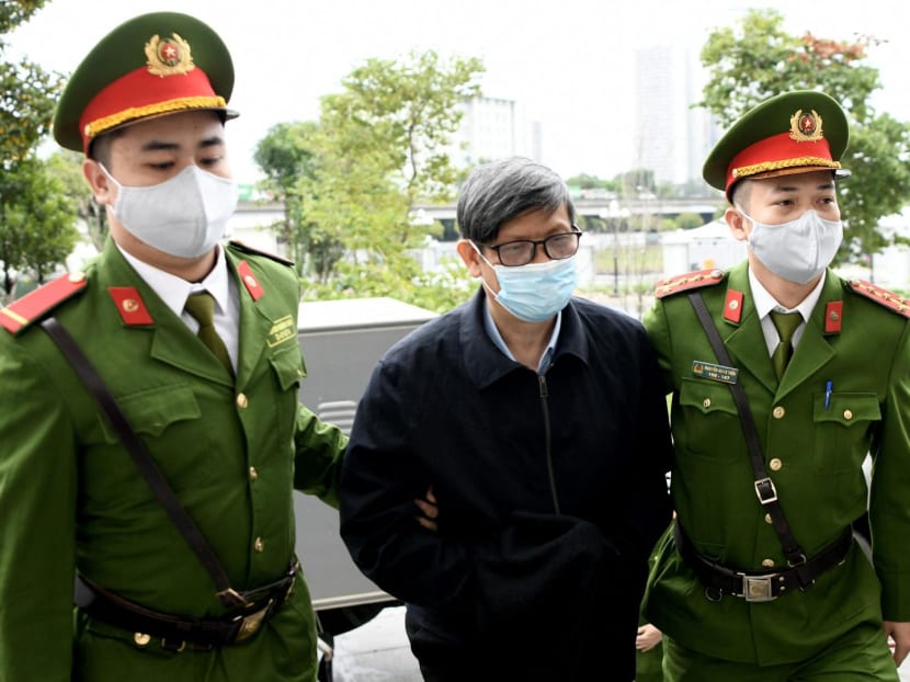 Vietnam's former minister of health Nguyen Thanh Long (centre) is led into a court by police for his anti-corruption trial over Covid test kit production bribes in Hanoi on Jan 3, 2024. Vietnam's former minister of health Nguyen Thanh Long (centre) is led into a court by police for his anti-corruption trial over Covid test kit production bribes in Hanoi on Jan 3, 2024.