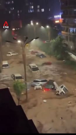 Floodwaters from Typhoon Bavi sweep vehicles away in China