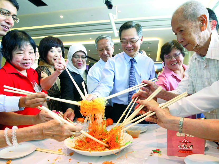 From left: Parliamentary Secretary (Health and Transport) Muhammad Faishal Ibrahim, a senior citizen living in the west, Senior Minister of State (Health and Manpower) Amy Khor, Speaker of Parliament and Jurong GRC MP Halimah Yacob, Jurong Health Board Chairman Lim Yong Wah, Health Minister Gan Kim Yong, Government Parliamentary Committee for Health member and Sembawang GRC MP Ellen Lee and a senior citizen  tossing yusheng at  the topping out ceremony of Ng Teng Fong General Hospital yesterday. 
Photo: Ernest Chua