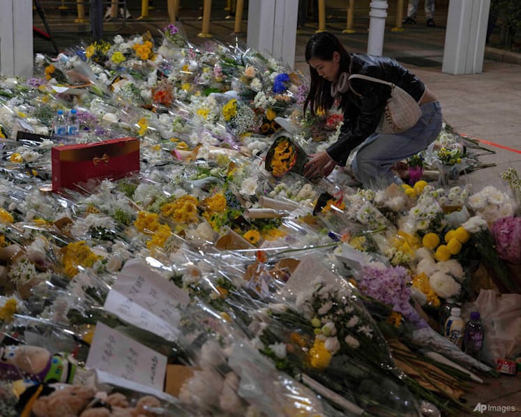 Mourners flock to site of deadly Hong Kong blaze as Beijing warns against protests
