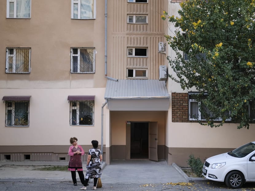 Local residents stand outside the apartment block where the suspect in Tuesday's terrorist attack in New York lived between 1996-2006, according to police records, in Tashkent, Uzbekistan on Wednesday, Nov 1, 2017. The window to the right on the ground floor is where Sayfullo Saipov lived. Photo: AP