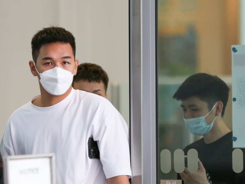 Victor Wong Wai Lok (left) leaving the State Courts on March 3, 2022.