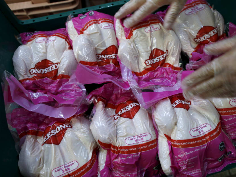 A worker arranges vacuum-packed chickens to be blast frozen at Kee Song Food Corporation's poultry slaughterhouse. The company is among the 13 fresh chicken suppliers who have been fined by the Competition and Consumer Commission of Singapore (CCCS) for engaging in anti-competitive arrangements.