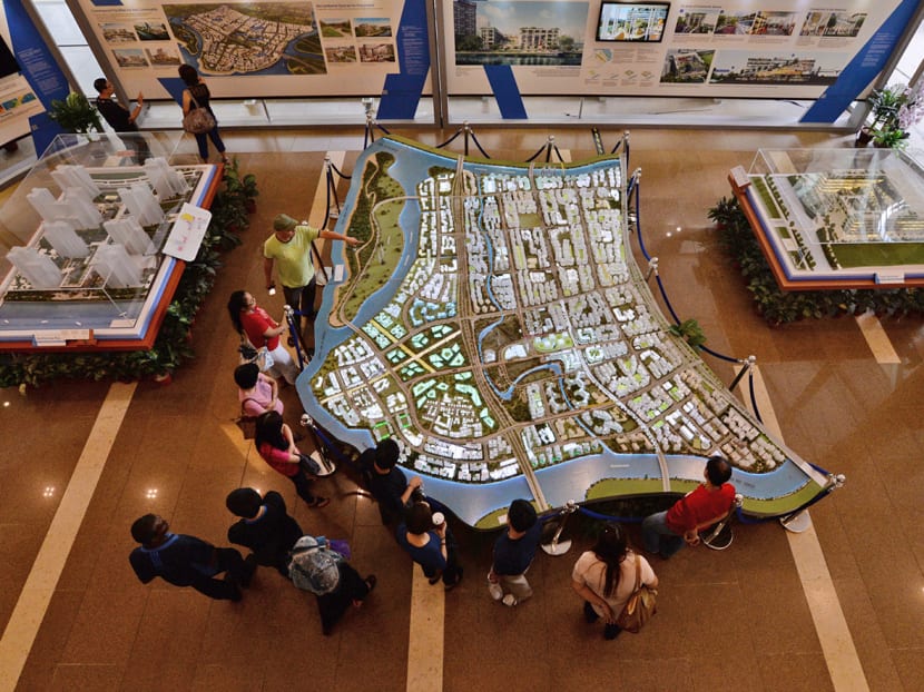People looking at a model of an upcoming public housing estate. People looking at a model of an upcoming public housing estate.