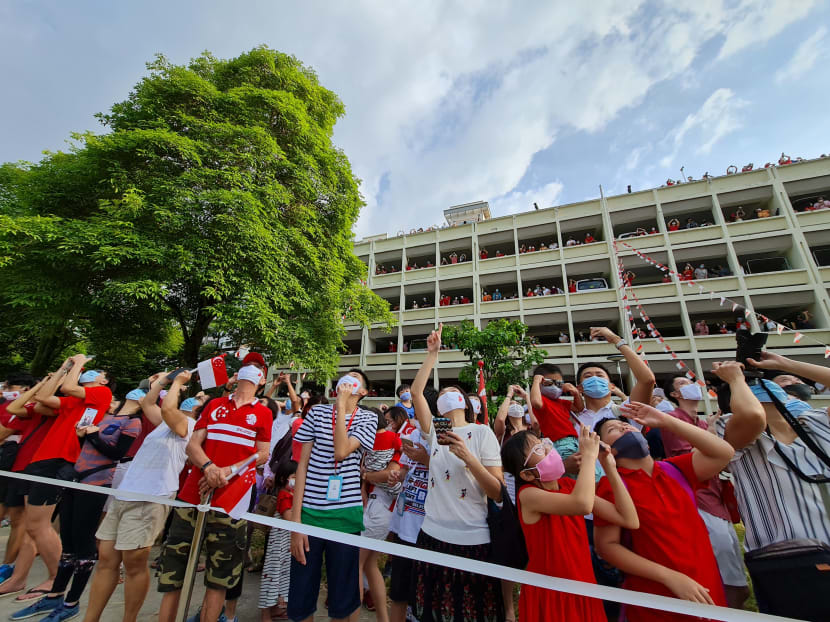 Crowds look on as the Red Lions prepare to land at an open field opposite Blk 285C Toh Guan Road during the National Day Parade on Aug 9, 2020. Crowds look on as the Red Lions prepare to land at an open field opposite Blk 285C Toh Guan Road during the National Day Parade on Aug 9, 2020.