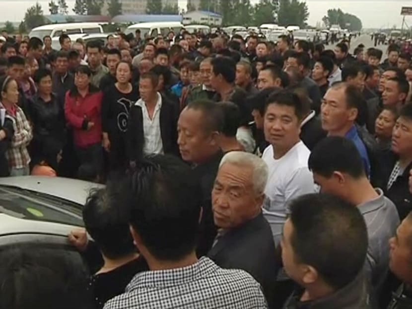 Gallery: China farm fire: Relatives scuffle with police, demand answers