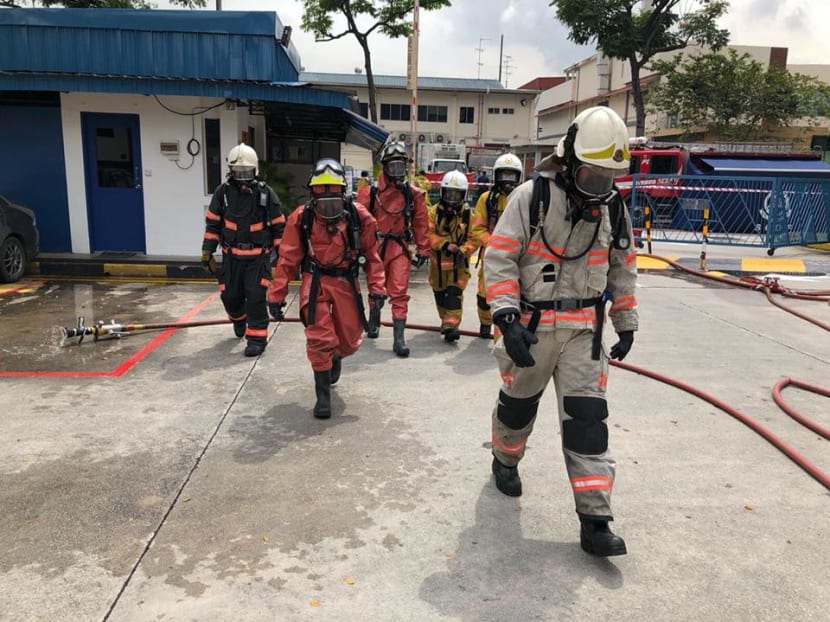 SCDF HazMat Specialists in protective suits entering the building at 1 Fishery Port Road after they were alerted to an incident of an ammonia leak. Photo: SCDF