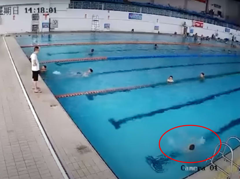 A screenshot from a security camera footage showing the final moments of a boy in a public pool in China before he drowned.