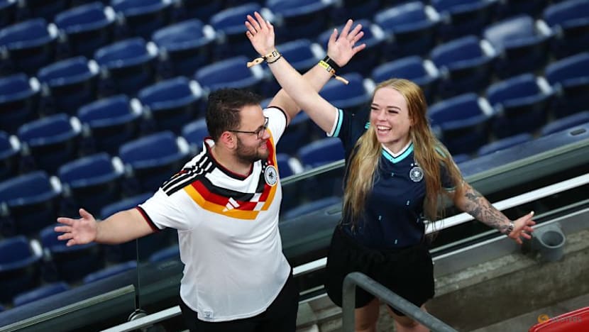 Rain sends Germany and Curacao fans on pre-match hunt for umbrellas and beer