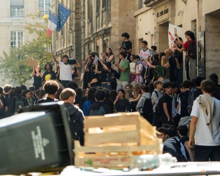 Teenager loses hand picking up grenade in France school protests