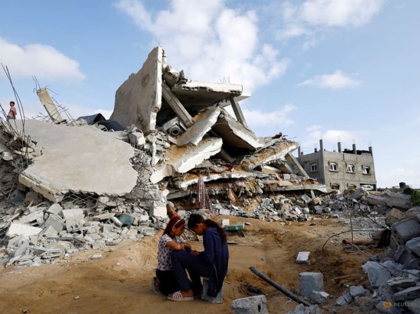 Palestinian children sit next to the site of an Israeli strike on a house, amid the ongoing conflict between Israel and the Palestinian Islamist group Hamas, in Rafah, in the southern Gaza Strip, April 21, 2024.