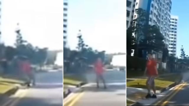 男子冲出马路挡车 见汽车减速后走回路边