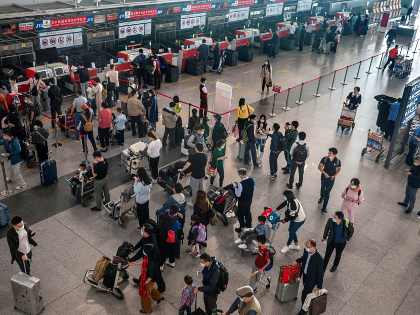 This photo taken on Sept 30, 2020 shows people queueing up to check in for domestic flights ahead of the country's national "Golden Week" holiday at Beijing's Capital International Airport.