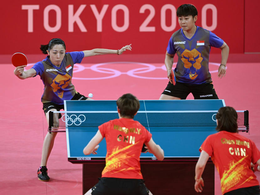 Singapore's Lin Ye (top right) and Singapore's Yu Meng Yu (top left) compete during their women's team quarterfinals table tennis match against China at the Tokyo Metropolitan Gymnasium during the Tokyo 2020 Olympic Games in Tokyo on Aug 3, 2021.