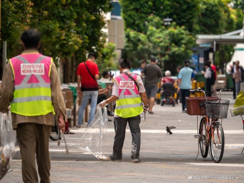 Offenders carrying out a corrective work order session in Singapore.