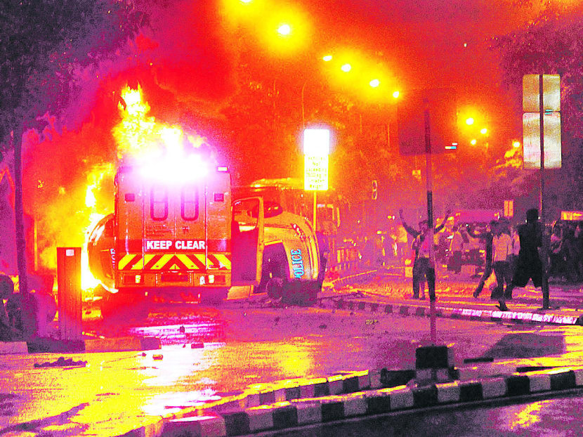 An ambulance was set on fire as an angry mob swarmed the streets in Little India late last night. Photo: Ooi Boon Keong