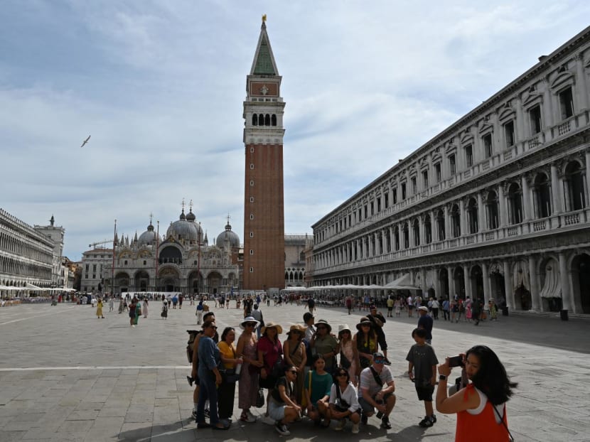 Tourists taking a group photo at St Mark's square in Venice, Italy on July 31, 2023. Tourists taking a group photo at St Mark's square in Venice, Italy on July 31, 2023.