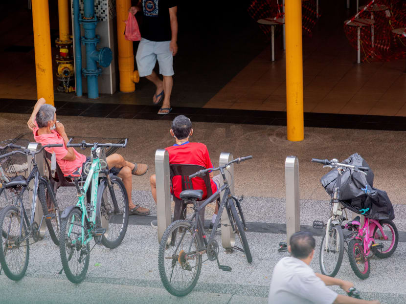 Two seniors sitting outside a food centre on April 29, 2020.  Photo: Ili Nadhirah Mansor/TODAY