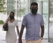 Woman who made construction workers hold up placards demanding payment fined, along with husband