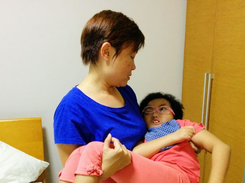 Caring for a high-support special needs child can be extremely challenging. Here, the writer Tham Yin May carries her daughter Vera, who has been diagnosed with Trisomy 18. Photo: Tham Yin May