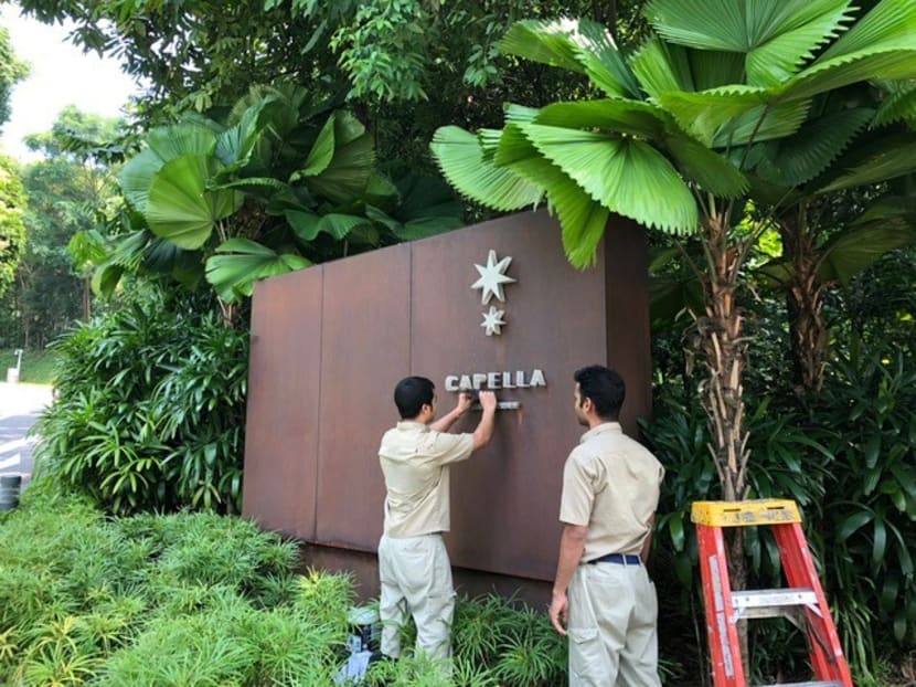 Workers preparing for the historic summit at Capella Hotel.