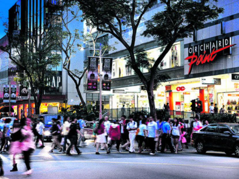 Pedestrians walk across Orchard Road near Frasers Centrepoint Ltd.'s The Centrepoint mall, left, and OG Pte Ltd.'s Orchard Point mall during the evening rush hour in Singapore, on Monday, Sept. 10, 2012. Fraser & Neave Ltd., the 129-year-old conglomerate selling its brewery business, is poised to fracture further as the chance to own a piece of Singapore's most famous shopping strip lures buyers. Photographer: Munshi Ahmed/Bloomberg
