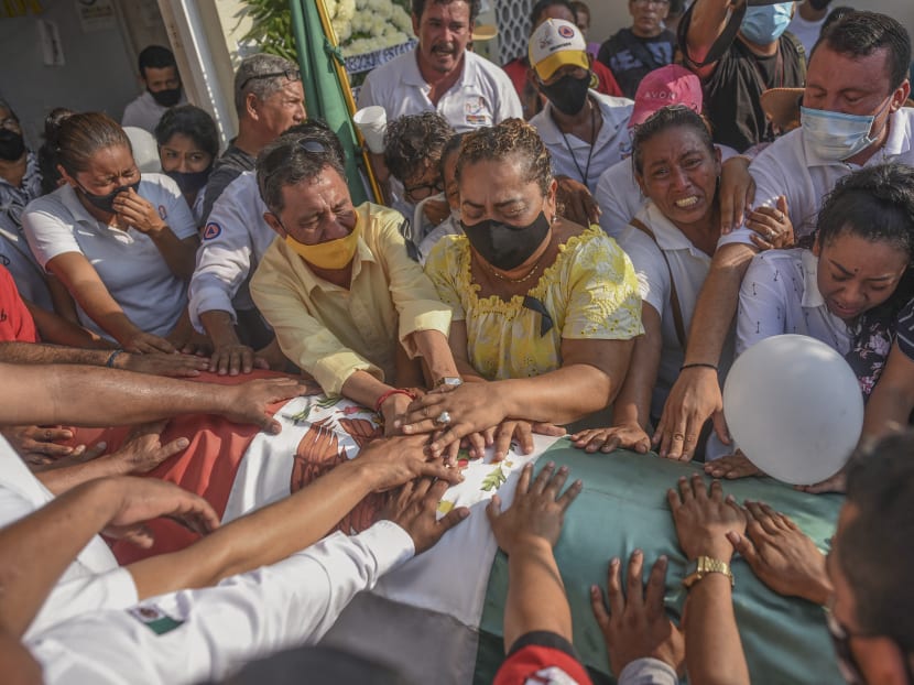 Relatives and friends of the Mayor of Jamapa, Florisel Rios Delfin take part in her funeral at the municipal cemetery in Jamapa, Veracruz state, Mexico on Nov 12, 2020 after she was murdered the day before.