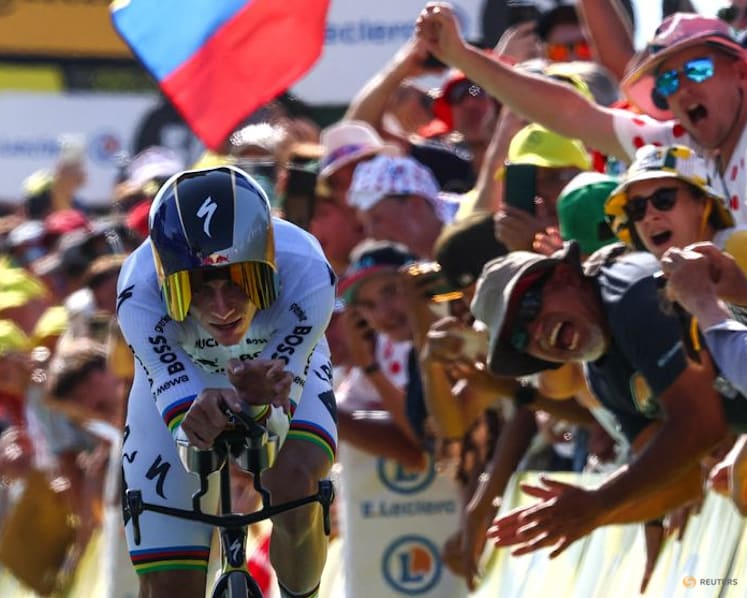 Evenepoel wins time trial to cut Pogacar's lead